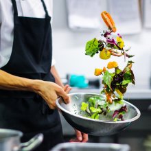Photo of a chef cleaning salad at Watershed