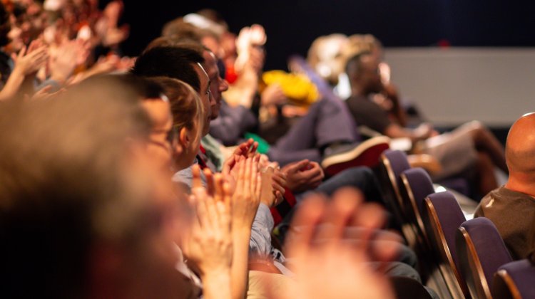 Cinema Rediscovered audience members seated in the cinema engaging in applause