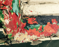 Layers of red, green and yellow peeling paint