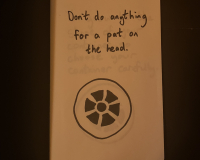 A page from a notebook with a drawing of a plughole and the words "Don't do anything for a pat on the head".