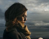 Alison on a beach holding a sea gooseberry