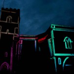 Holy Trinity Church with projections on it - so the lines of the edges of the building are lit up with neon colours