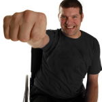 A photo of laurence Clark, is hand and arm raised making a fist towards the camera so his hand appears very big.