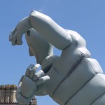 the head and arms of the inflatable against a blue sky