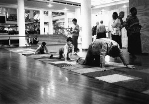 a black and white image of children climbing across textured mats - laughing