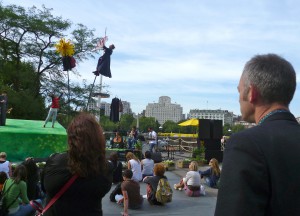 The back of Charles watching The Garden - a show with artists on sway poles on the terrace outside the south bank centre