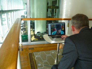 charles looking at a computer screen on which we can see Simon Mckeown