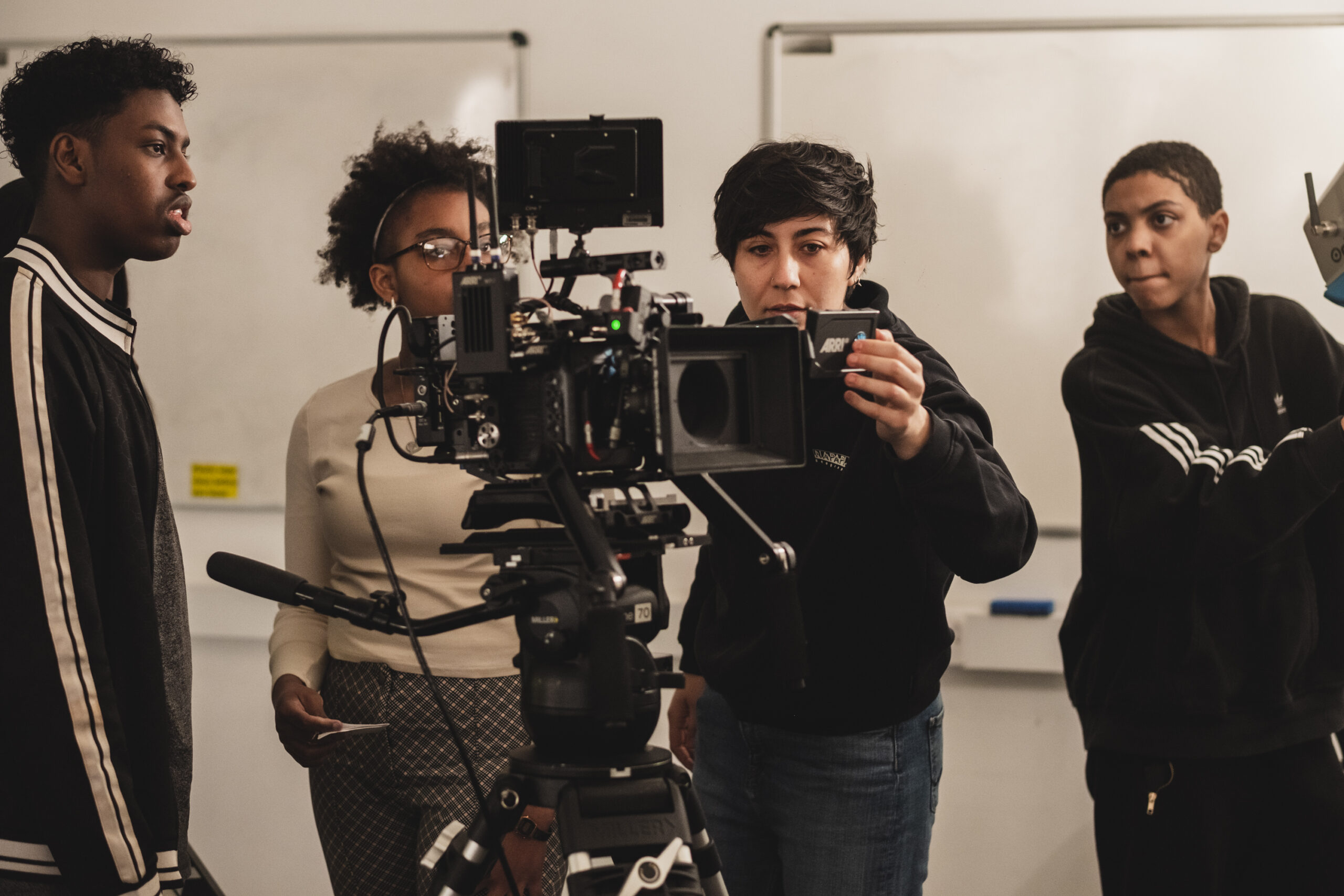 Young filmmakers gather around a camera operator