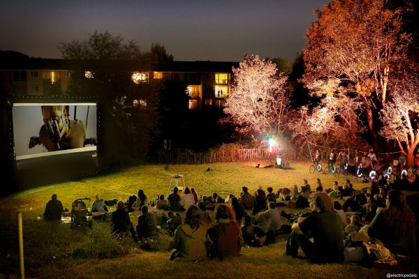 A landscape shot of a late night, outdoor film screening