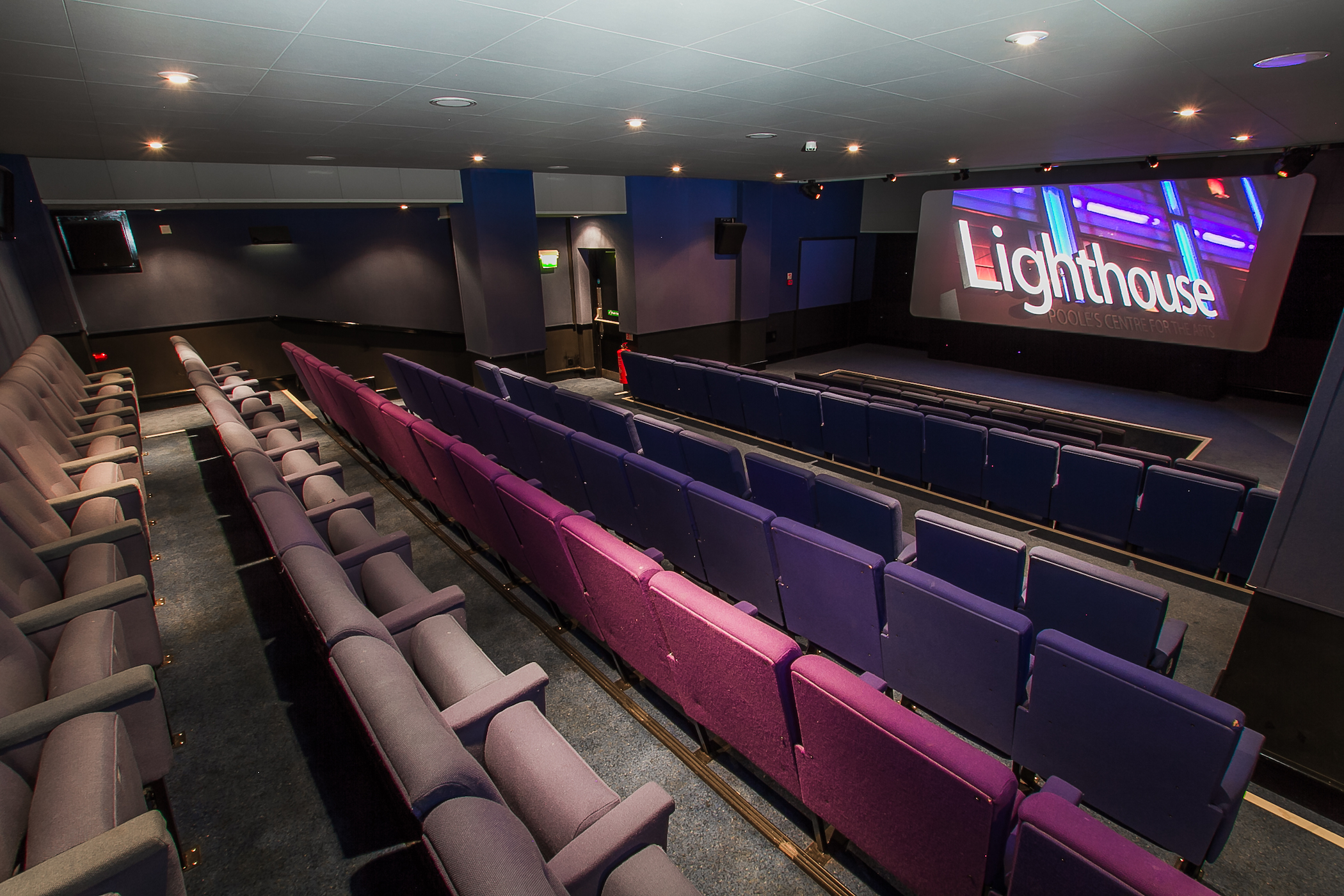 Interior of The Lighthouse cinema, an auditorium with purple seats