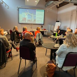 group of film hub members sat on chairs in a meeting room talking and sharing