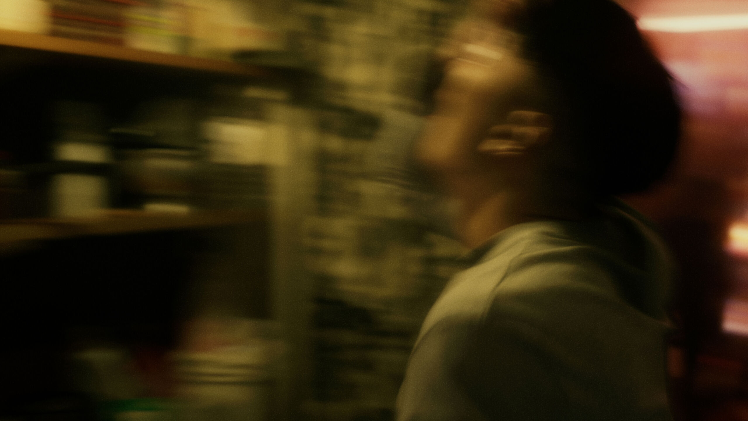 blurry scene of a man in a yellow lit room, it looks sweaty and messy