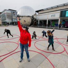 Photo of a group of people with VR masks on in Millennium Square, Bristol
