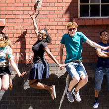 4 young people from Rife Magazine jumping in the air
