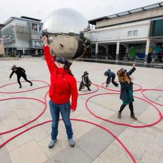 Photo of 5 people wearing VR headsets and taking part in Dancing Shadows