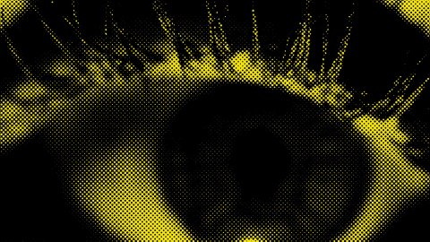 A close up of an eye under a yellow and black filter